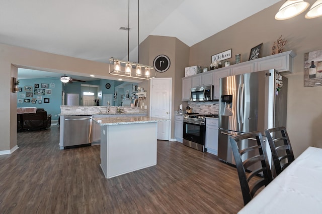 104 Sandstone Trl, Crestview, FL 32539 - kitchen with appliances with stainless steel finishes, a peninsula, dark wood-style floors, ceiling fan, and high vaulted ceiling