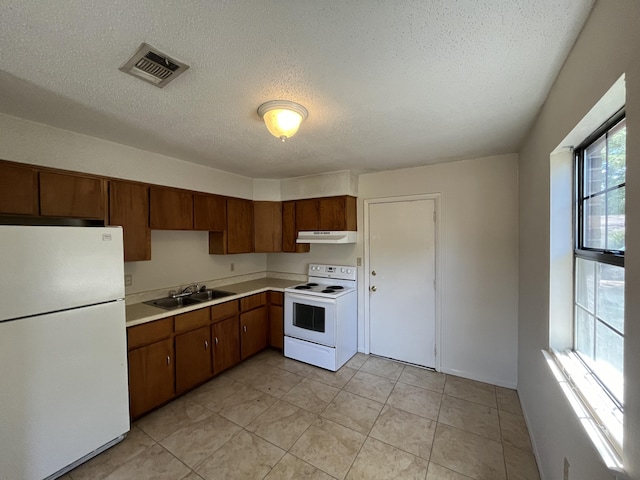 816 Lark St Unit 5, 6, 7, 8, Fort Walton Beach, FL 32547 - kitchen featuring white appliances, a sink, under cabinet range hood, light countertops, and a textured ceiling