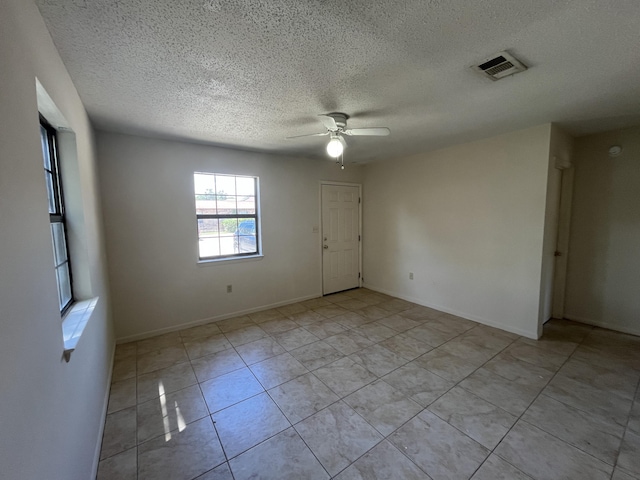 816 Lark St Unit 5, 6, 7, 8, Fort Walton Beach, FL 32547 - empty room with a textured ceiling, ceiling fan, light tile patterned flooring, and baseboards