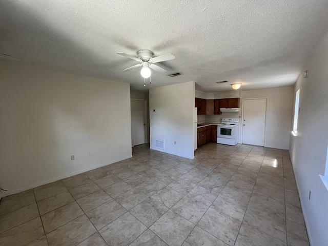 816 Lark St Unit 5, 6, 7, 8, Fort Walton Beach, FL 32547 - unfurnished living room featuring ceiling fan, a textured ceiling, light tile patterned floors, and baseboards