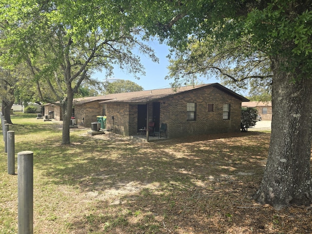 816 Lark St Unit 5, 6, 7, 8, Fort Walton Beach, FL 32547 - back of house featuring cooling unit, a yard, and brick siding