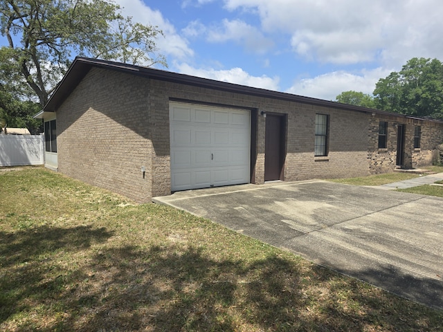816 Lark St Unit 5, 6, 7, 8, Fort Walton Beach, FL 32547 - view of front of property with brick siding, a garage, concrete driveway, and a front yard