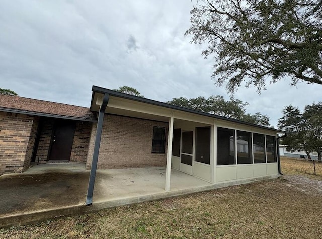816 Lark St Unit 5, 6, 7, 8, Fort Walton Beach, FL 32547 - back of house featuring a patio area, a sunroom, and brick siding