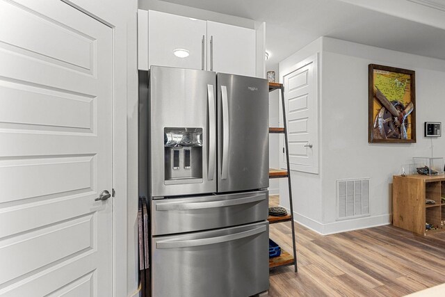 736 Commanche St, Fort Walton Beach, FL 32547 - kitchen featuring stainless steel fridge with ice dispenser, light wood-style floors, white cabinets, and baseboards