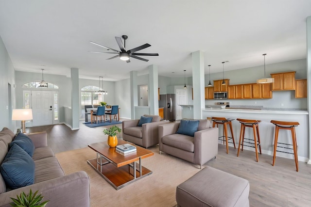 3167 Border Creek Dr, Crestview, FL 32539 - living area with light wood-type flooring, a chandelier, baseboards, and a ceiling fan