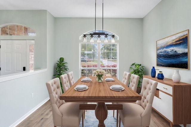 3167 Border Creek Dr, Crestview, FL 32539 - dining area with light wood-style flooring, baseboards, and a chandelier
