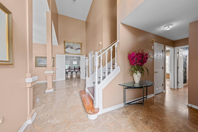 859 Mande Ct, Shalimar, FL 32579 - foyer entrance with stairway, baseboards, decorative columns, and a high ceiling