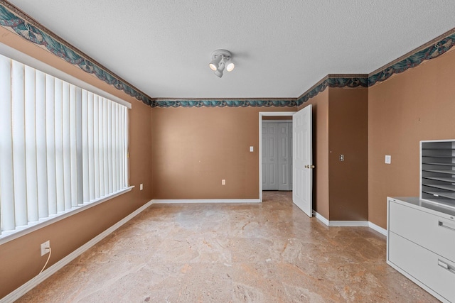 859 Mande Ct, Shalimar, FL 32579 - spare room featuring a textured ceiling and baseboards