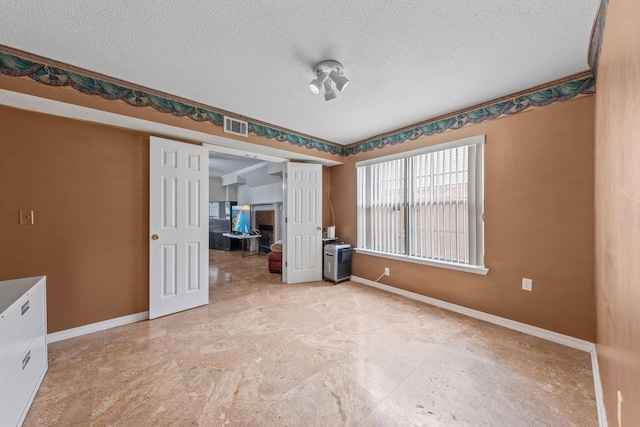 859 Mande Ct, Shalimar, FL 32579 - spare room with baseboards and a textured ceiling