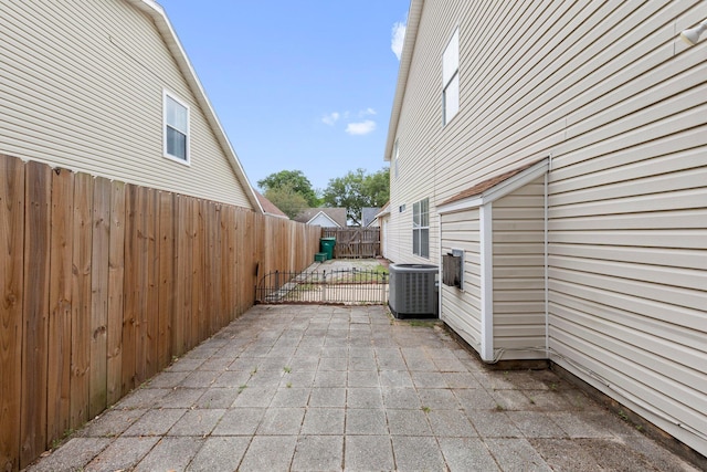 859 Mande Ct, Shalimar, FL 32579 - view of property exterior featuring central air condition unit, a patio area, and fence