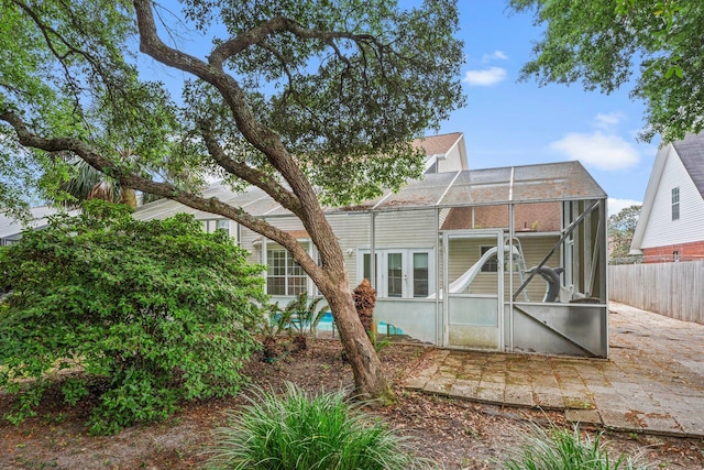 859 Mande Ct, Shalimar, FL 32579 - rear view of property with fence, a patio, glass enclosure, and french doors