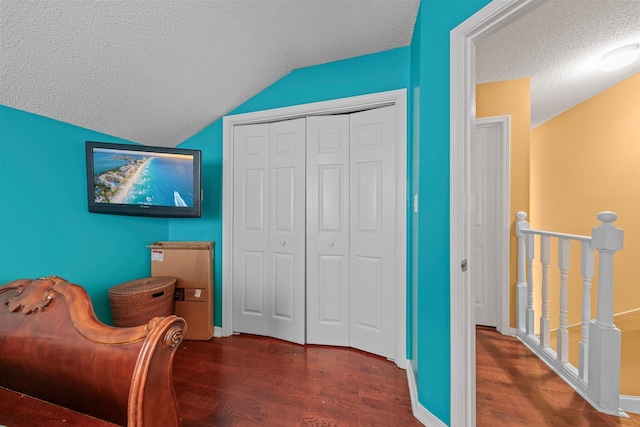 859 Mande Ct, Shalimar, FL 32579 - sitting room with a textured ceiling, an upstairs landing, wood finished floors, vaulted ceiling, and baseboards