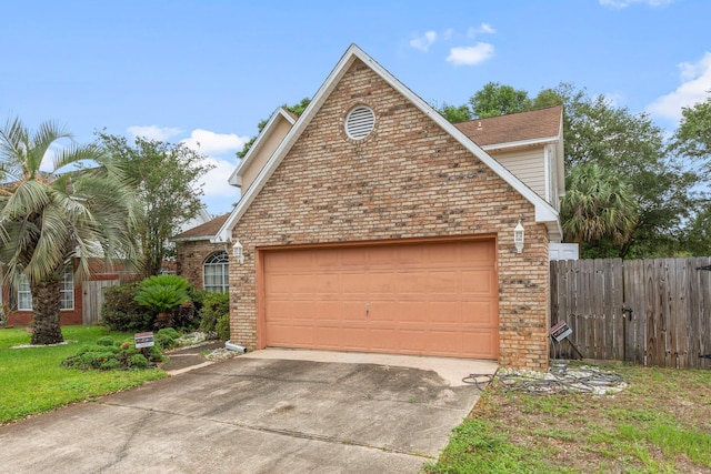 859 Mande Ct, Shalimar, FL 32579 - view of front of property featuring brick siding, concrete driveway, an attached garage, and fence
