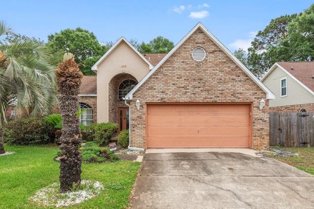 859 Mande Ct, Shalimar, FL 32579 - traditional-style house with an attached garage, driveway, and brick siding