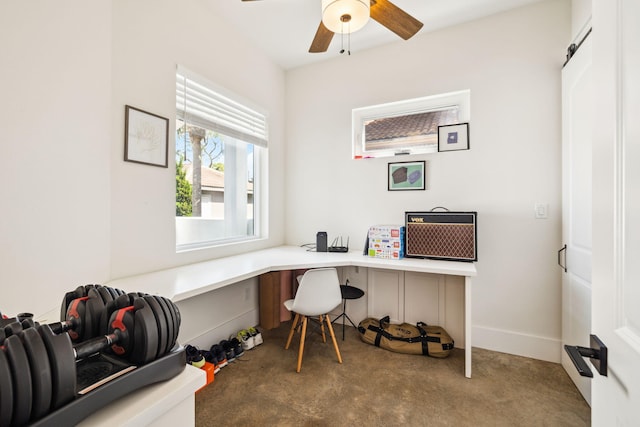 office space featuring carpet floors, a ceiling fan, built in study area, and baseboards