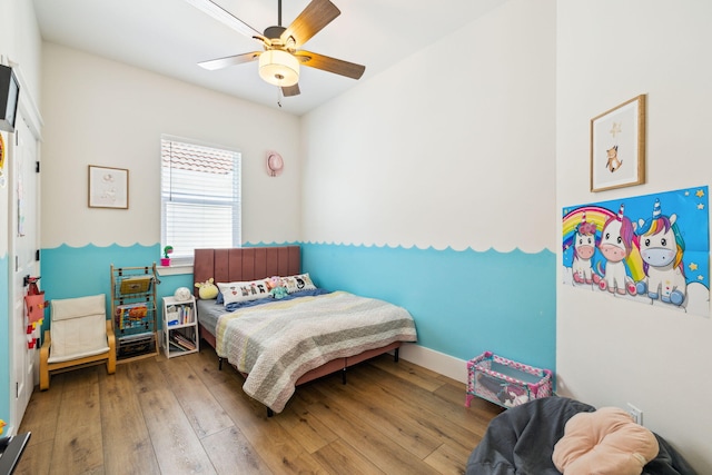 bedroom with hardwood / wood-style floors and ceiling fan