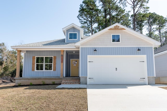 1432 Madelyn Woods Dr, Pensacola, FL 32506 - view of front of home featuring concrete driveway, a garage, covered porch, and roof with shingles