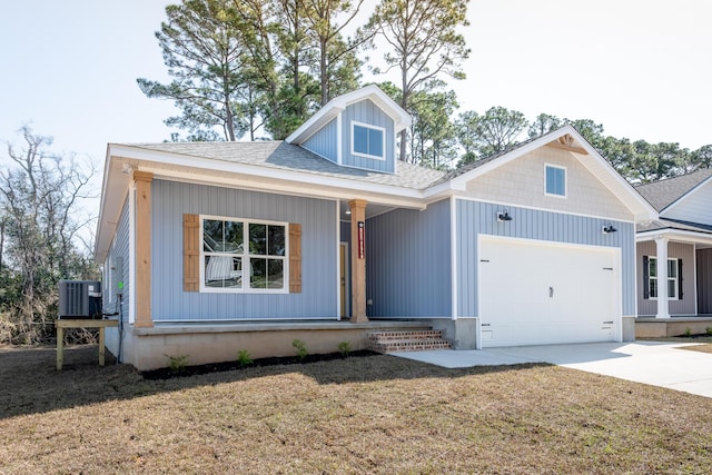 1432 Madelyn Woods Dr, Pensacola, FL 32506 - view of front facade featuring a porch, an attached garage, central AC unit, driveway, and roof with shingles