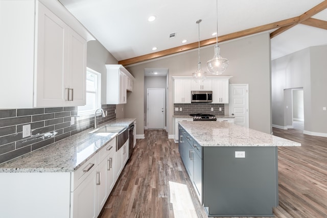 1432 Madelyn Woods Dr, Pensacola, FL 32506 - kitchen featuring stainless steel appliances, a sink, white cabinets, backsplash, and baseboards