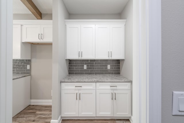 1432 Madelyn Woods Dr, Pensacola, FL 32506 - kitchen with light wood finished floors, backsplash, white cabinets, light stone countertops, and baseboards