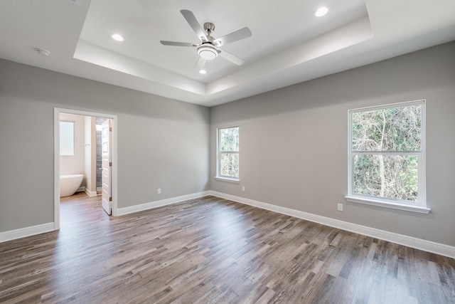 1432 Madelyn Woods Dr, Pensacola, FL 32506 - unfurnished room with a raised ceiling, wood finished floors, recessed lighting, a ceiling fan, and baseboards
