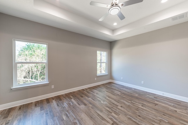 1432 Madelyn Woods Dr, Pensacola, FL 32506 - unfurnished room featuring healthy amount of natural light, wood finished floors, a raised ceiling, and recessed lighting