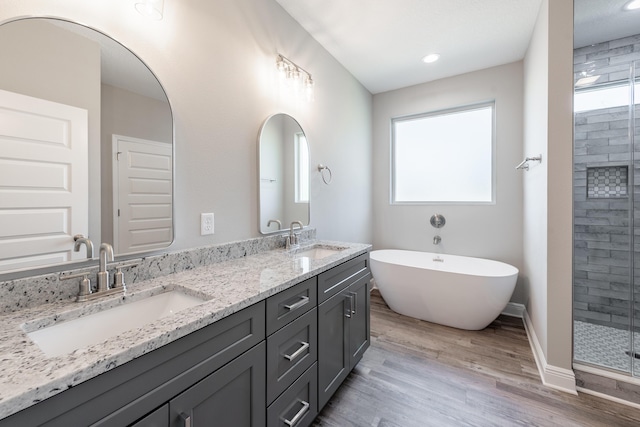 1432 Madelyn Woods Dr, Pensacola, FL 32506 - full bathroom featuring wood finished floors, plenty of natural light, a stall shower, double vanity, and recessed lighting