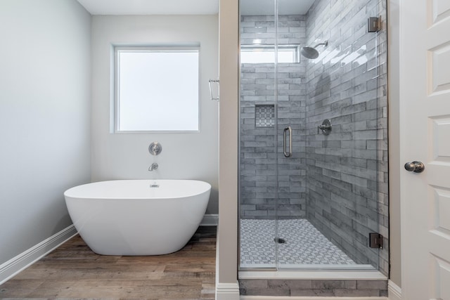 1432 Madelyn Woods Dr, Pensacola, FL 32506 - bathroom featuring a shower stall, wood finished floors, a soaking tub, and baseboards