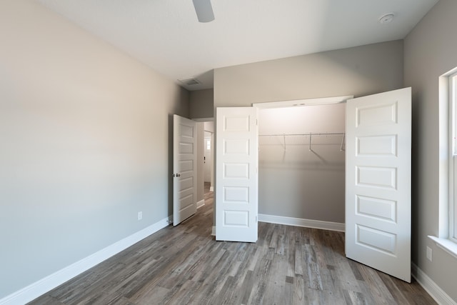 1432 Madelyn Woods Dr, Pensacola, FL 32506 - unfurnished bedroom featuring wood finished floors, a closet, baseboards, and a ceiling fan
