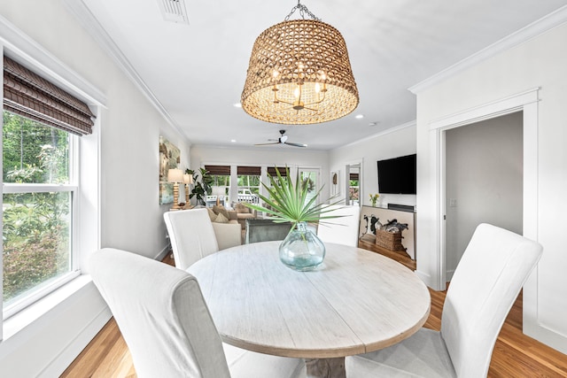 196 Summer Breeze Ln, Santa Rosa Beach, FL 32459 - dining space with healthy amount of natural light, crown molding, a chandelier, recessed lighting, and light wood-style floors