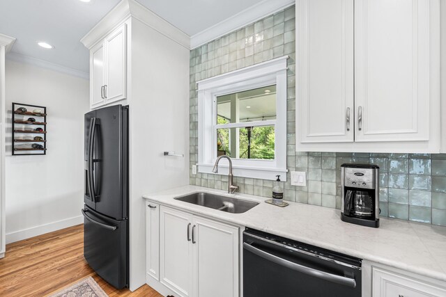 196 Summer Breeze Ln, Santa Rosa Beach, FL 32459 - kitchen with black fridge with ice dispenser, dishwashing machine, a sink, crown molding, and white cabinetry