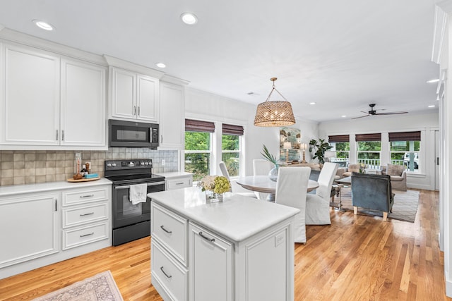 196 Summer Breeze Ln, Santa Rosa Beach, FL 32459 - kitchen featuring black range with electric cooktop, plenty of natural light, white cabinetry, and recessed lighting