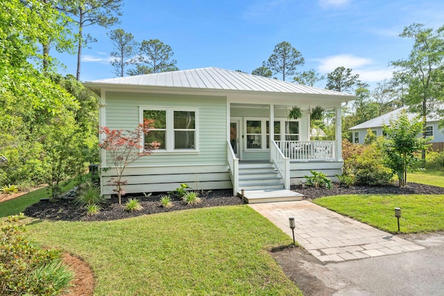196 Summer Breeze Ln, Santa Rosa Beach, FL 32459 - view of front of property with a porch, a front yard, and metal roof