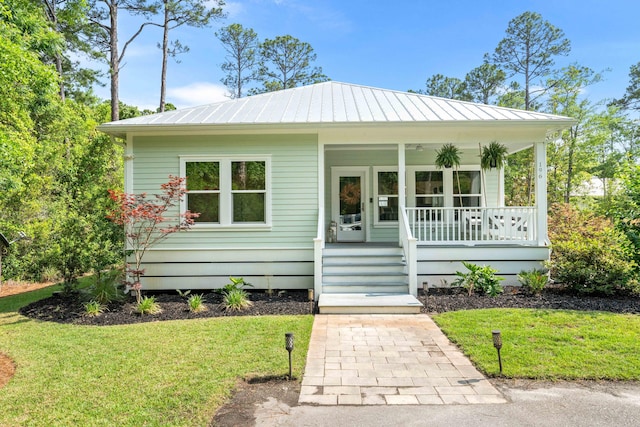 196 Summer Breeze Ln, Santa Rosa Beach, FL 32459 - view of front facade featuring covered porch, a front lawn, and a standing seam roof