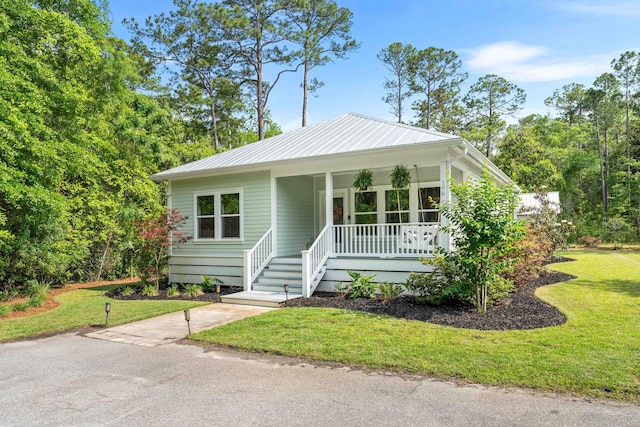 196 Summer Breeze Ln, Santa Rosa Beach, FL 32459 - view of front of house featuring a porch, a front yard, and metal roof