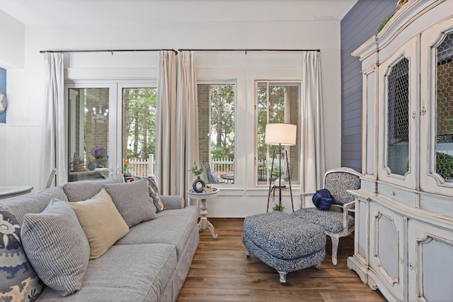 sunroom / solarium featuring wood finished floors and a decorative wall