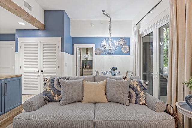 living area with a chandelier and wood finished floors