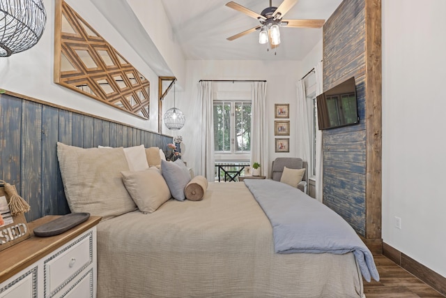 bedroom featuring wood finished floors, baseboards, and a ceiling fan