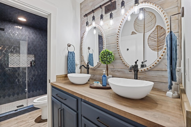 full bath with a shower stall, double vanity, and toilet