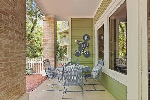 view of patio with outdoor dining area and fence
