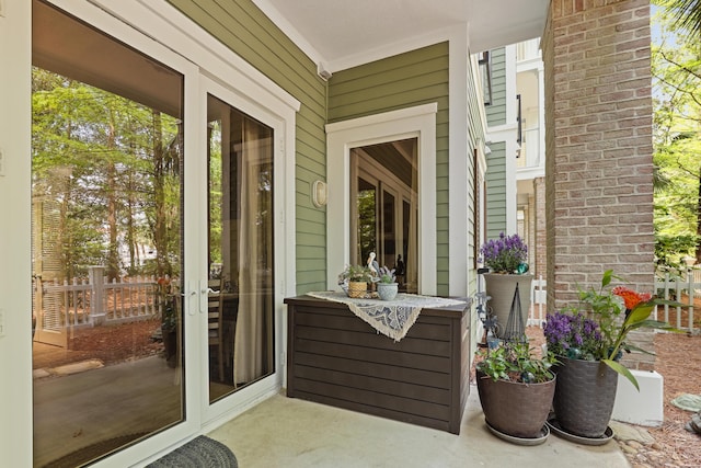 view of patio / terrace featuring fence and french doors