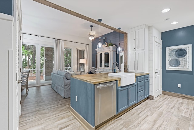 9300 Baytowne Wharf Blvd Unit 113, Miramar Beach, FL 32550 - kitchen featuring butcher block countertops, dishwasher, blue cabinetry, a sink, and light wood-style flooring