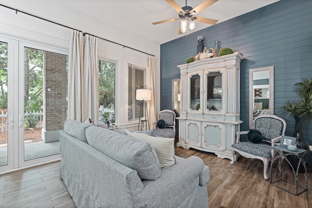 9300 Baytowne Wharf Blvd Unit 113, Miramar Beach, FL 32550 - living room featuring light wood finished floors, a ceiling fan, and wooden walls