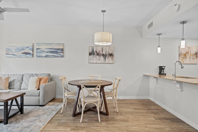 dining area featuring baseboards and wood finished floors