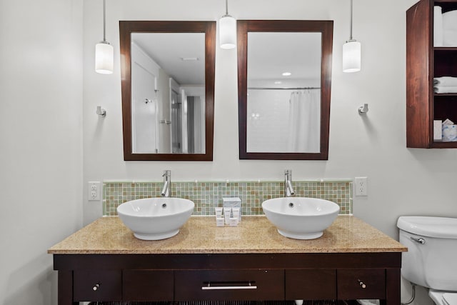 full bath featuring backsplash, toilet, and double vanity