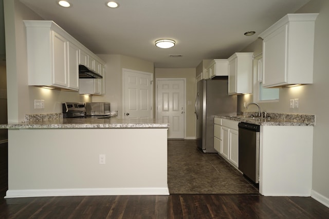 1422 Oakwood Lakes Blvd, Defuniak Springs, FL 32433 - kitchen featuring appliances with stainless steel finishes, a sink, wall chimney exhaust hood, light stone counters, and recessed lighting