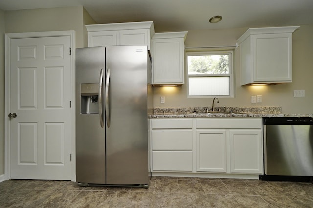 1422 Oakwood Lakes Blvd, Defuniak Springs, FL 32433 - kitchen featuring stainless steel appliances, a sink, light stone counters, and white cabinets