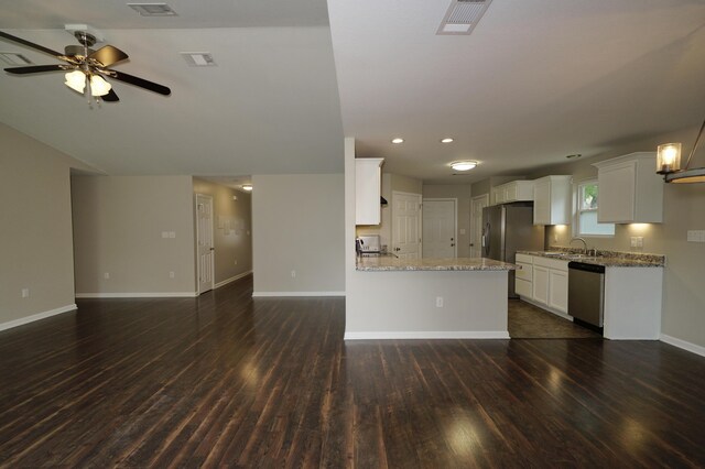 1422 Oakwood Lakes Blvd, Defuniak Springs, FL 32433 - kitchen with stainless steel appliances, open floor plan, dark wood finished floors, baseboards, and light stone countertops