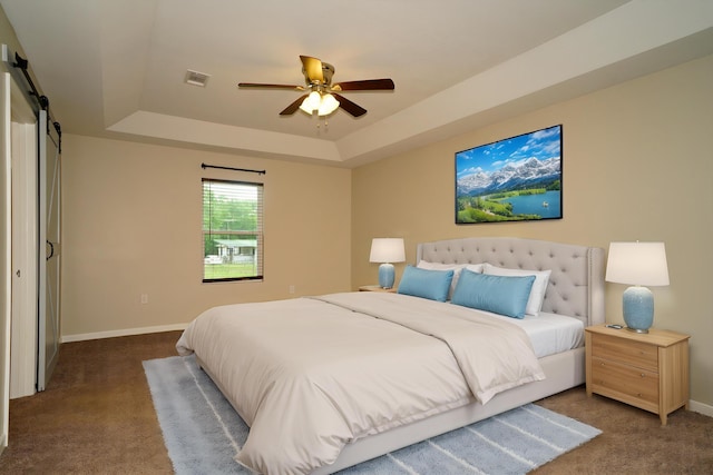 1422 Oakwood Lakes Blvd, Defuniak Springs, FL 32433 - carpeted bedroom with a raised ceiling, a barn door, baseboards, and ceiling fan