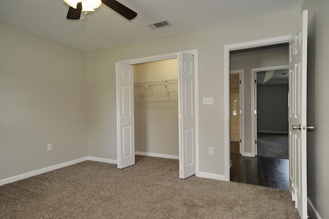 1422 Oakwood Lakes Blvd, Defuniak Springs, FL 32433 - unfurnished bedroom with dark carpet, baseboards, a closet, and ceiling fan